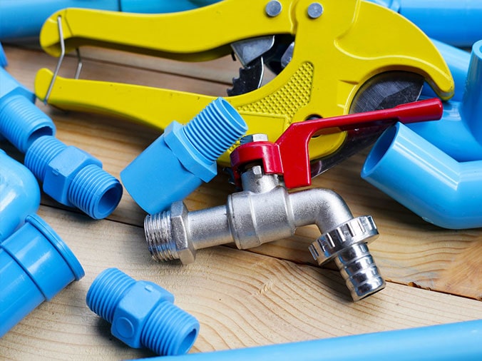 Blue PVC plumbing parts and tools